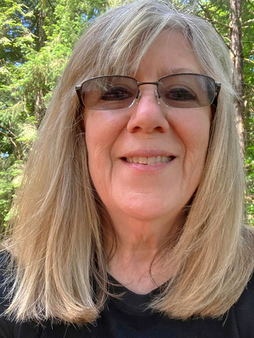 a woman with blonde hair wearing glasses